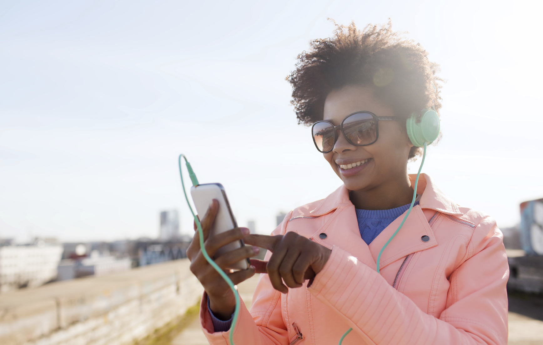 happy young woman with smartphone and headphones